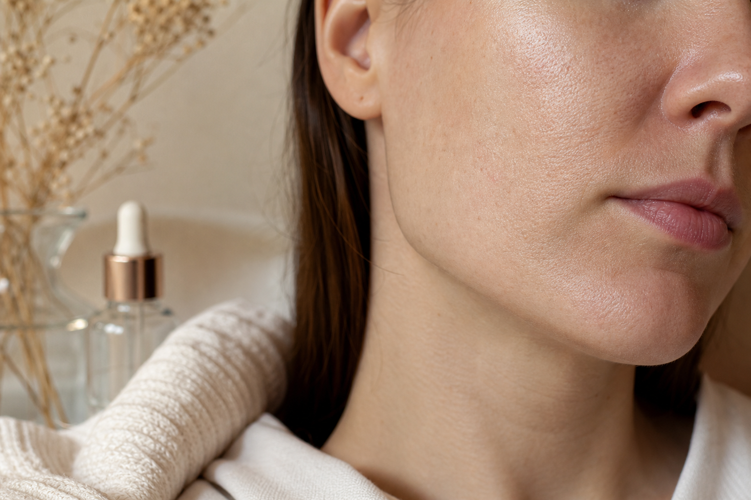 Real, non-airbrushed close-up of healthy treated skin texture on a cheek/jawline — visible pores and natural texture, soft even tone, no retouching. Anchors realistic expectations — not "flawless," but improved and real.
